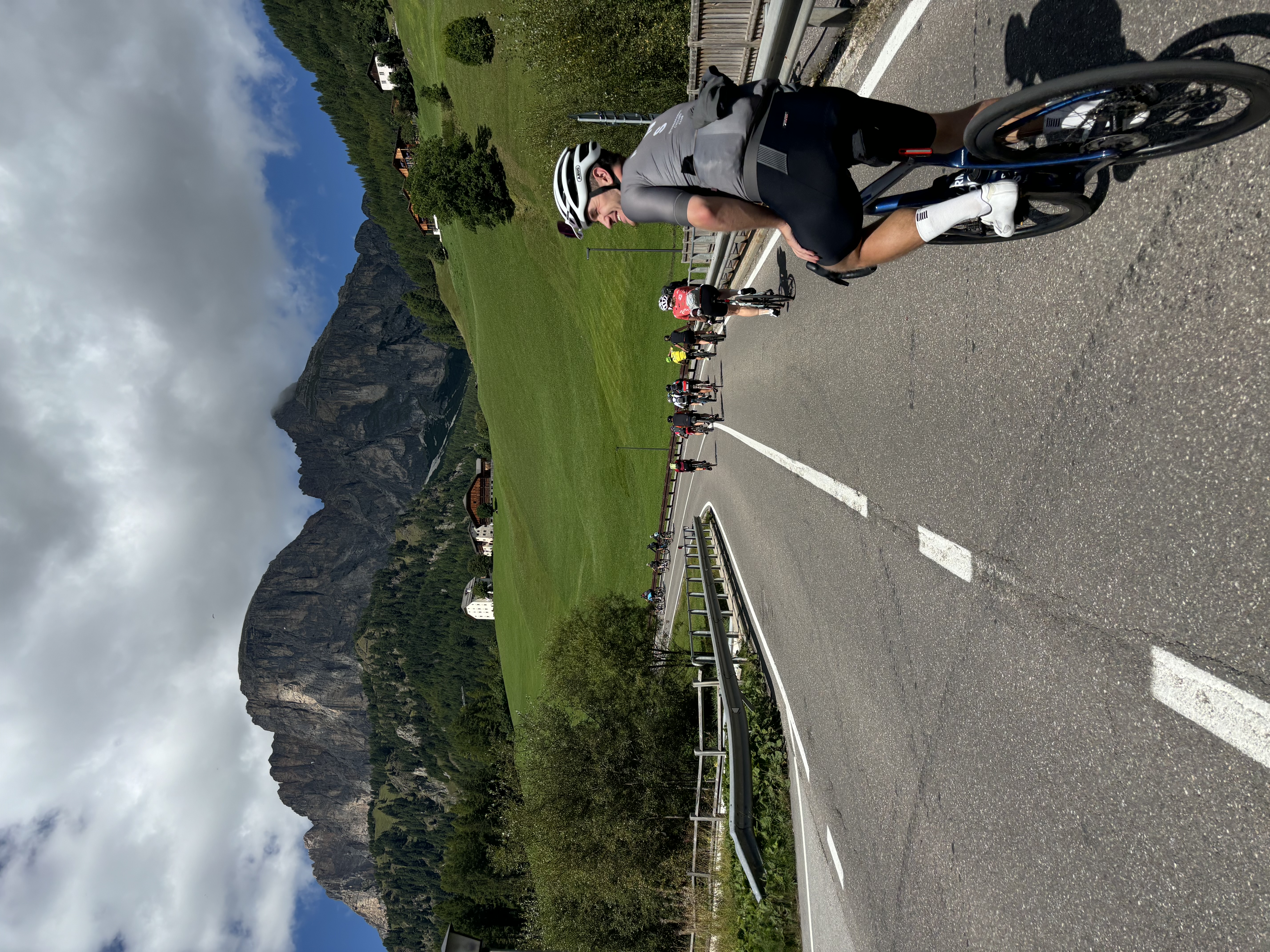 Cyclist riding toward mountains in Italy